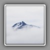 Mountain peak over clouds